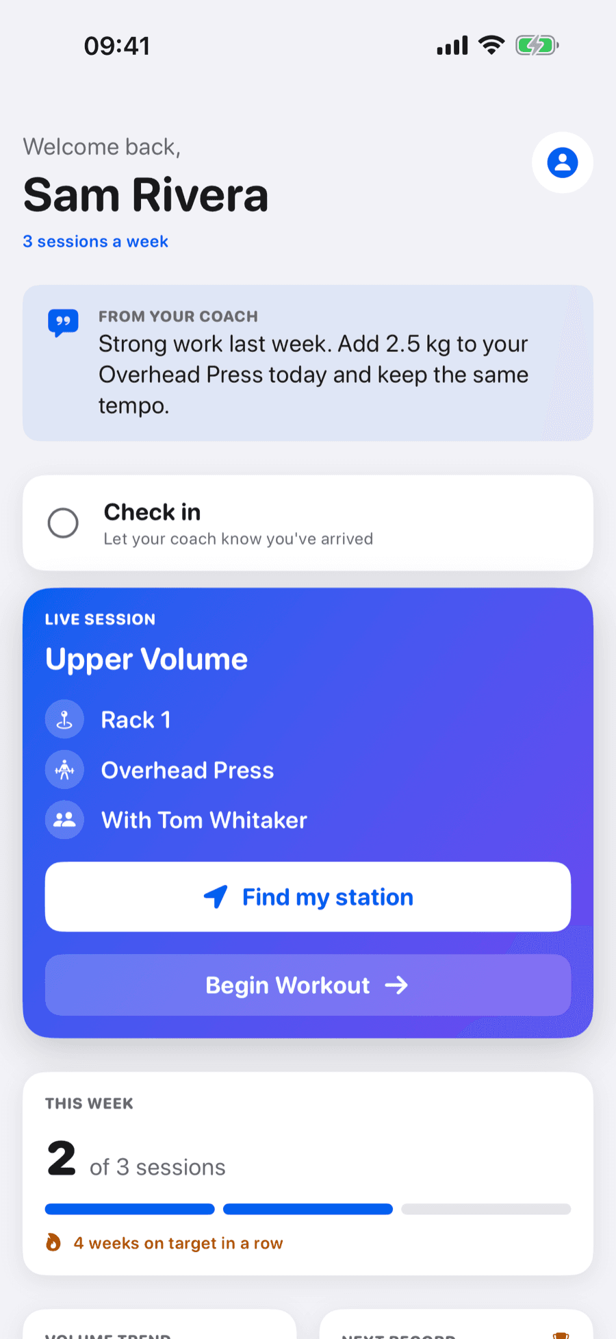 The GymSync member home in the demo gym: a note from the coach, a Check in button, and the live Upper Volume session showing Rack 1, Overhead Press and training partner Tom Whitaker, with Find my station and Begin Workout buttons above this week's progress